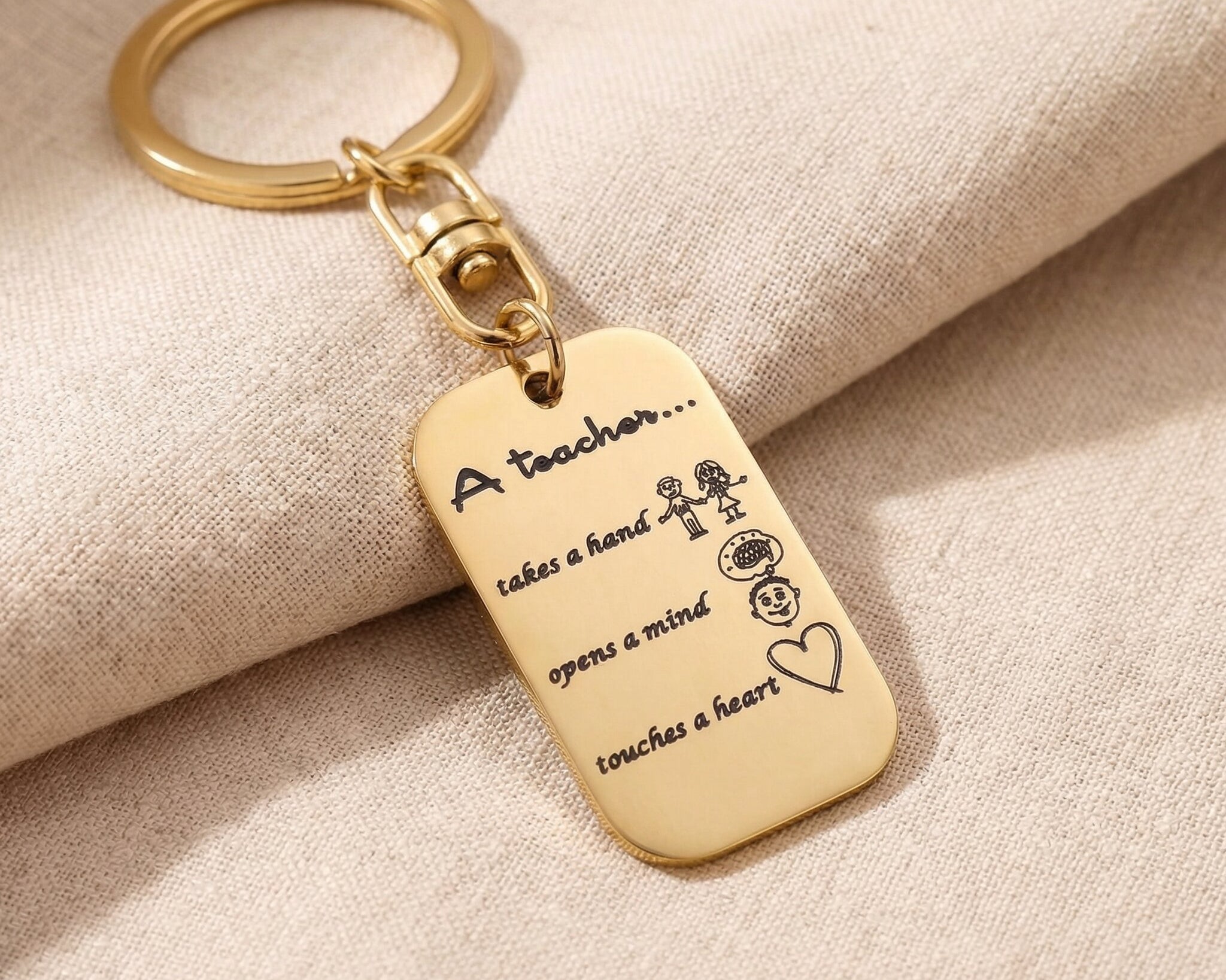 Personalised dog tag keyring in gold with engraved message, minimal modern design