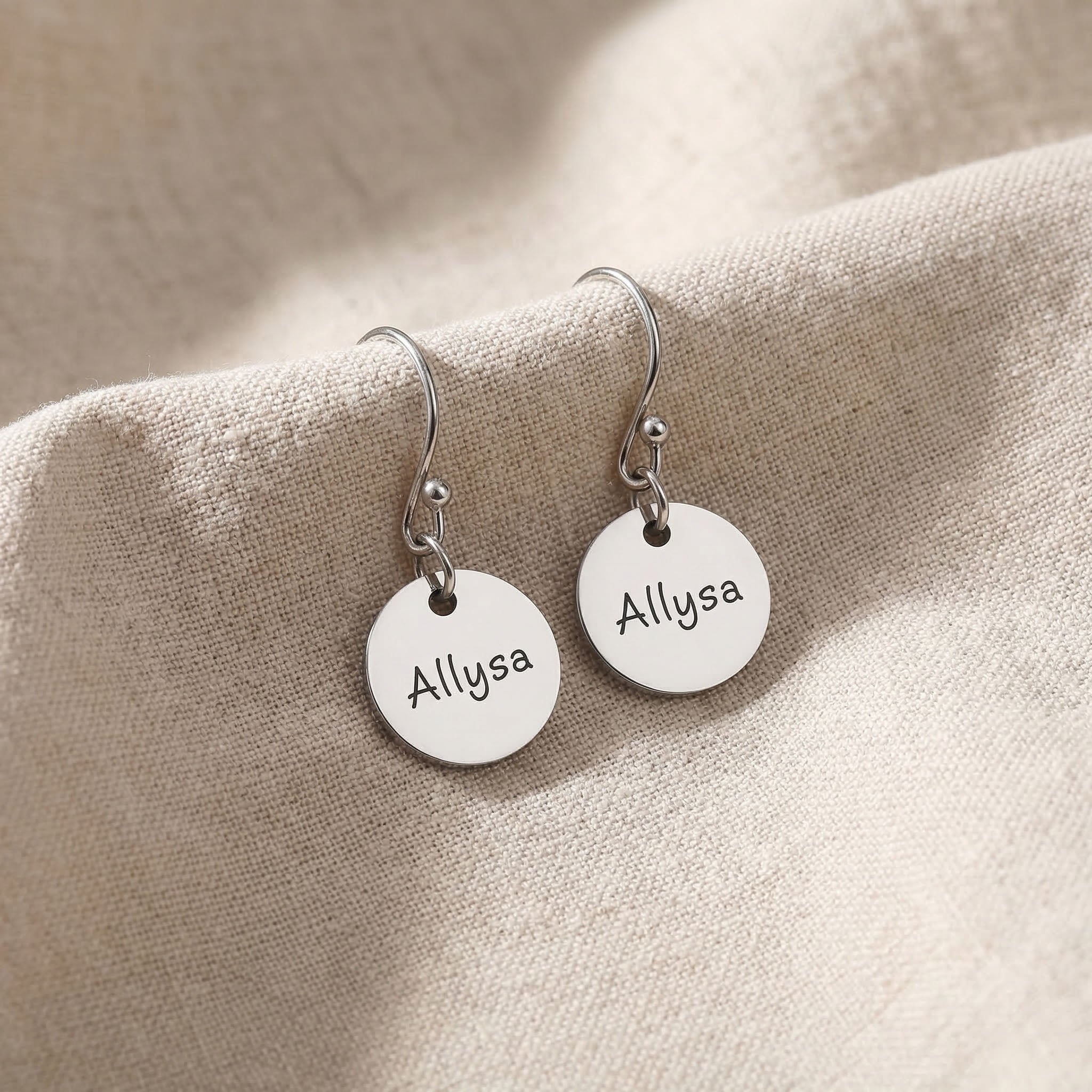 Silver personalised earrings with engraved name on disc design