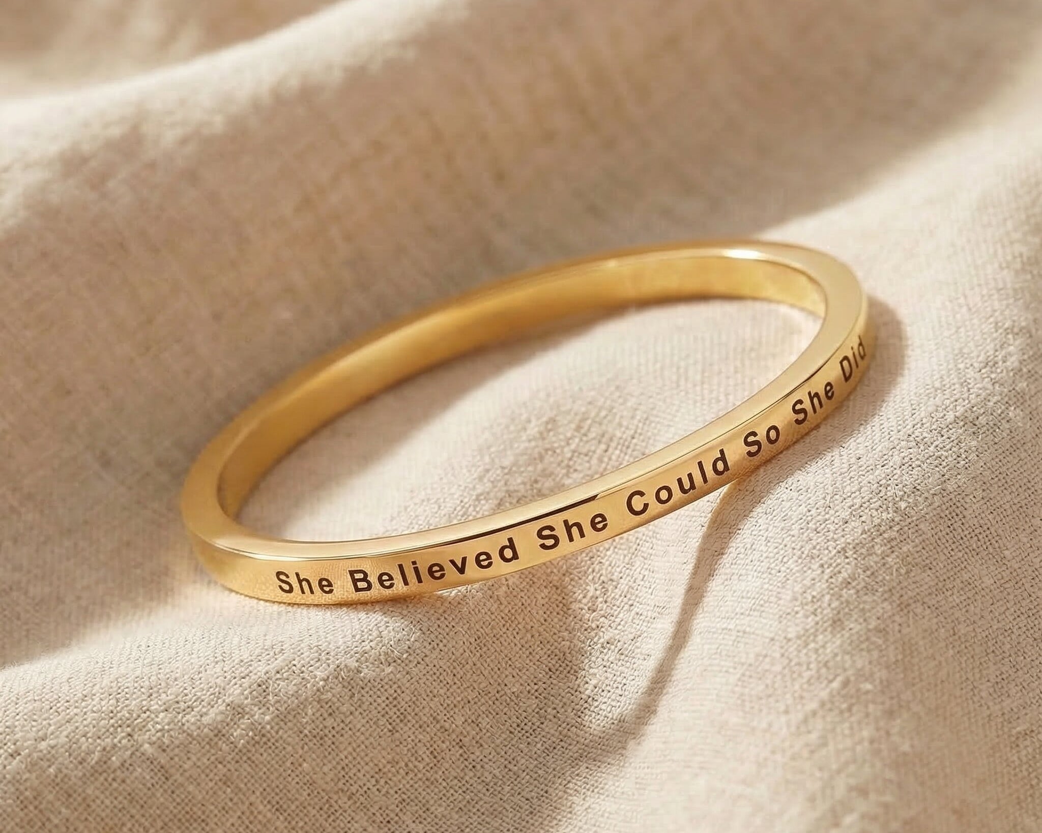 Personalised inspirational bangle in gold with engraved quote, elegant minimal design