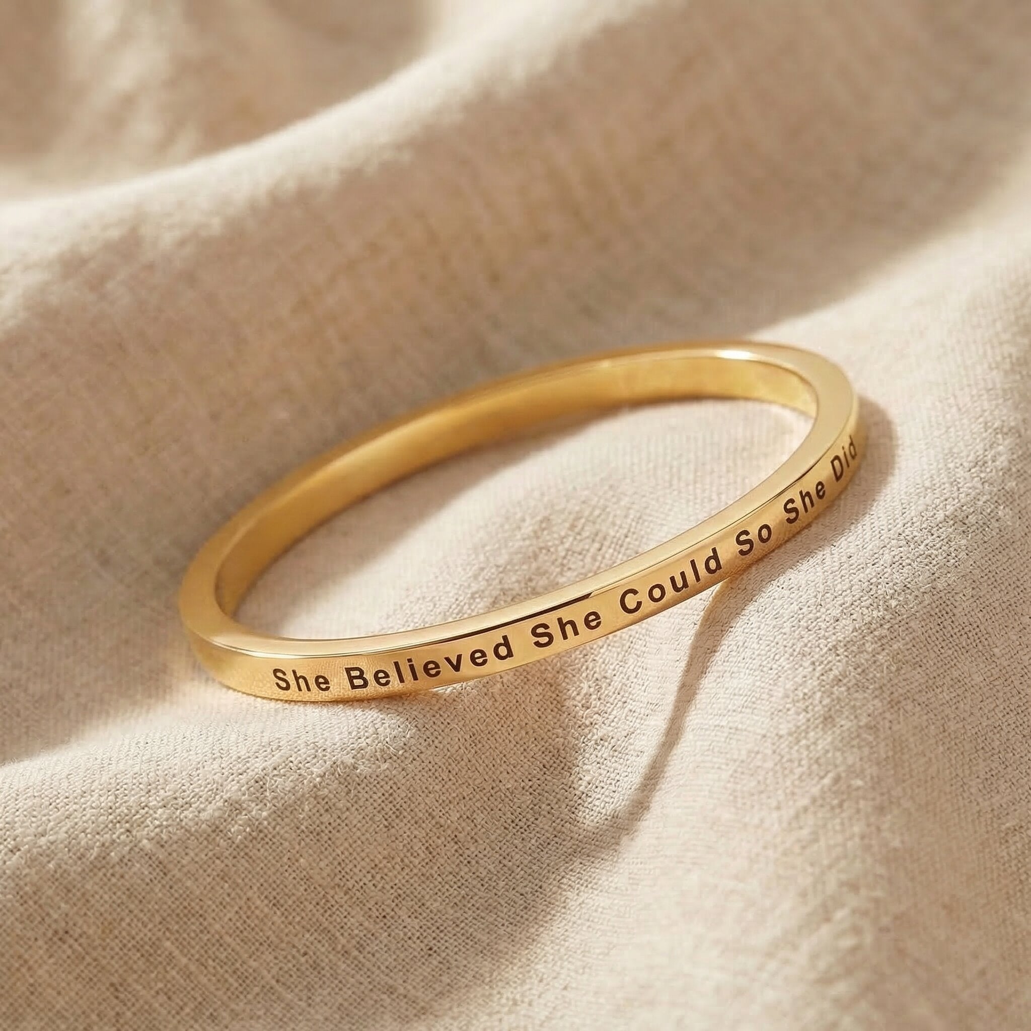 Personalised inspirational bangle in gold with engraved quote, elegant minimal design