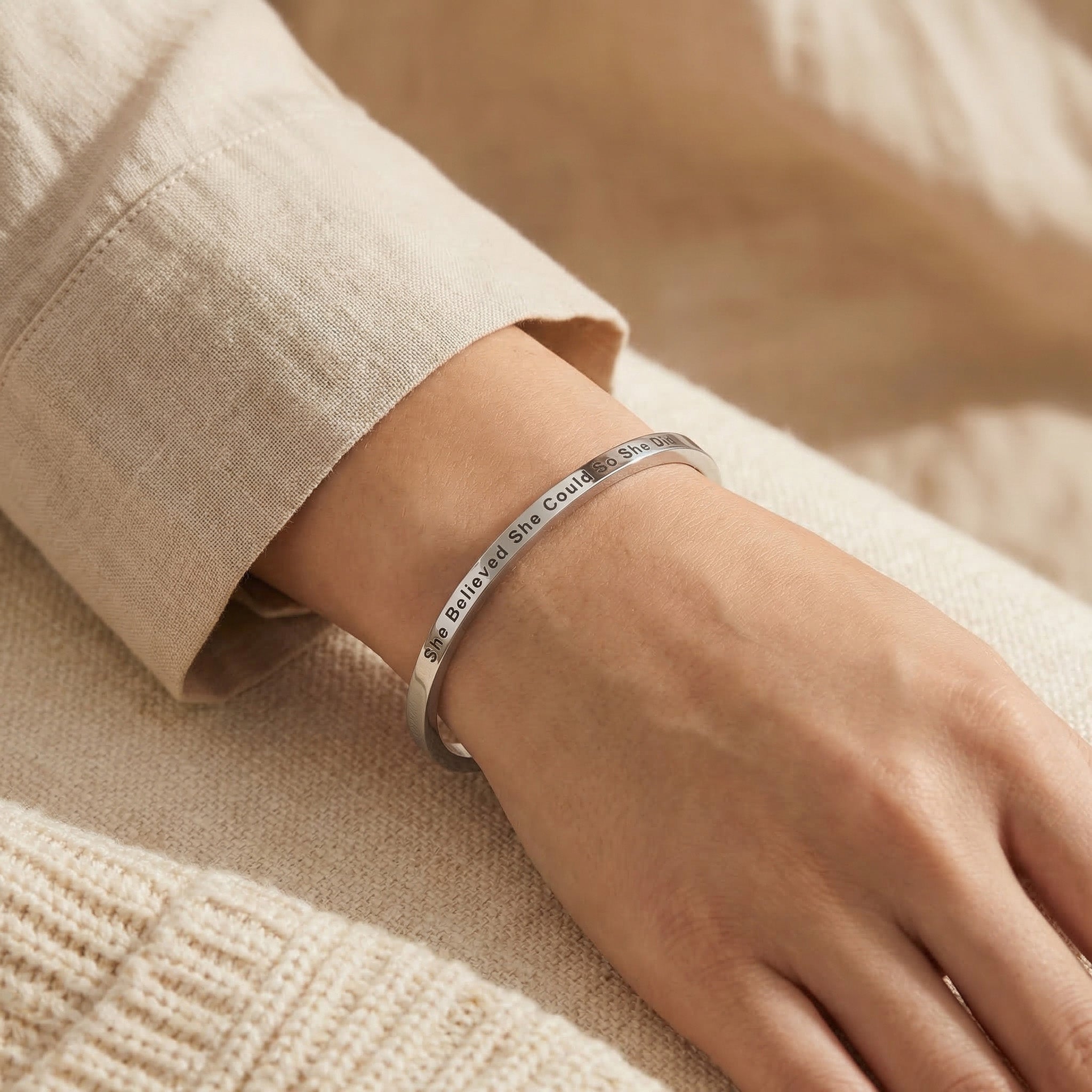 Woman wearing personalised inspirational bangle with engraved message, everyday jewellery style