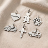 Personalised keyring charms in silver showing engraved name charms and symbol options