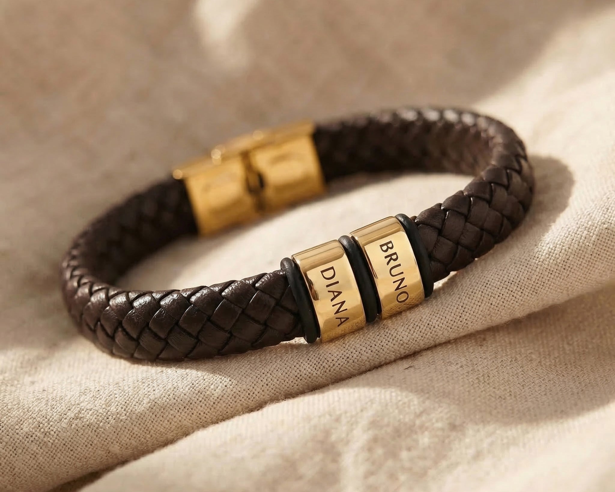 Personalised leather bracelet with gold engraved name charm, bold custom jewellery design