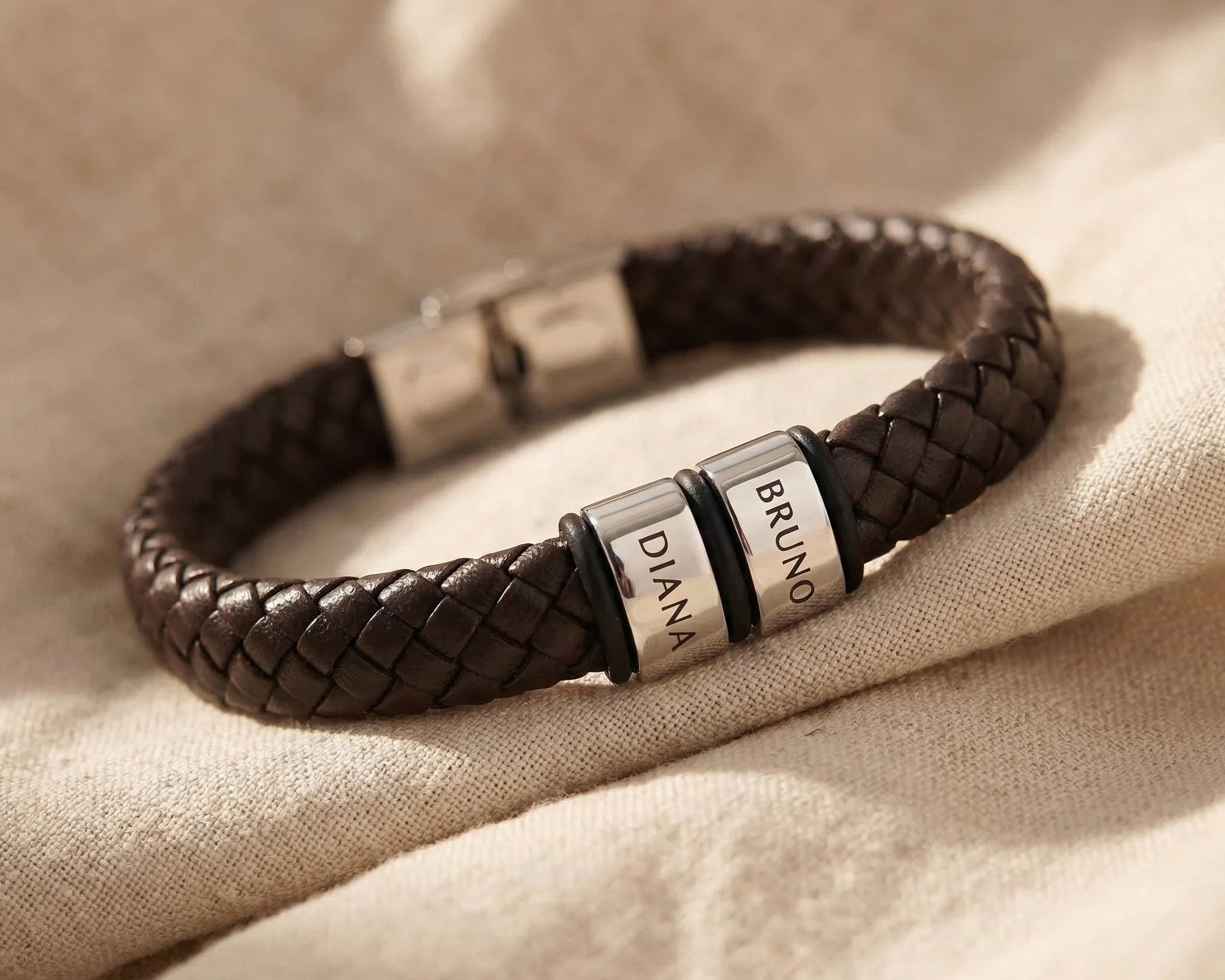 Personalised leather bracelet with silver engraved charms, classic custom jewellery piece