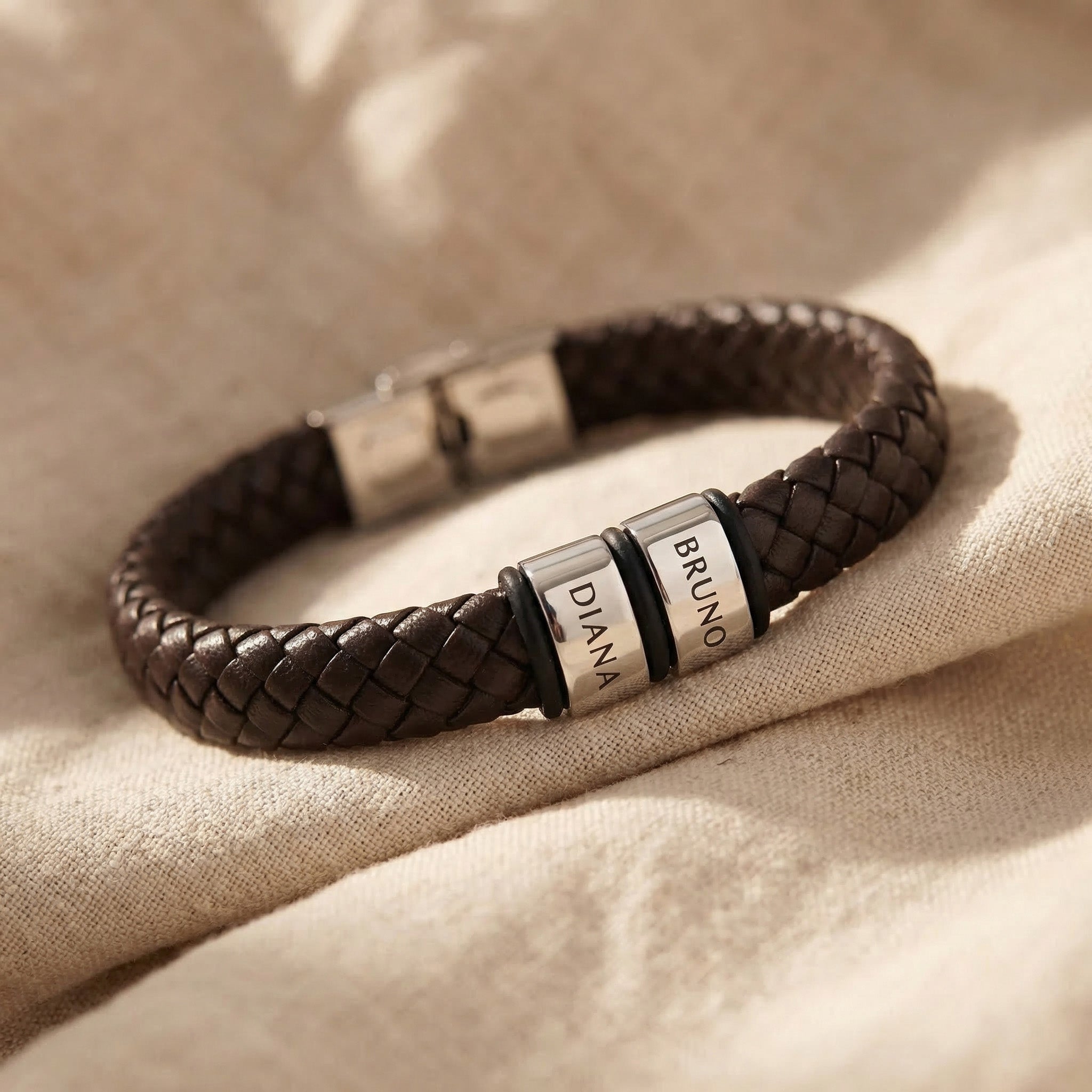 Personalised leather bracelet with silver engraved charms, classic custom jewellery piece
