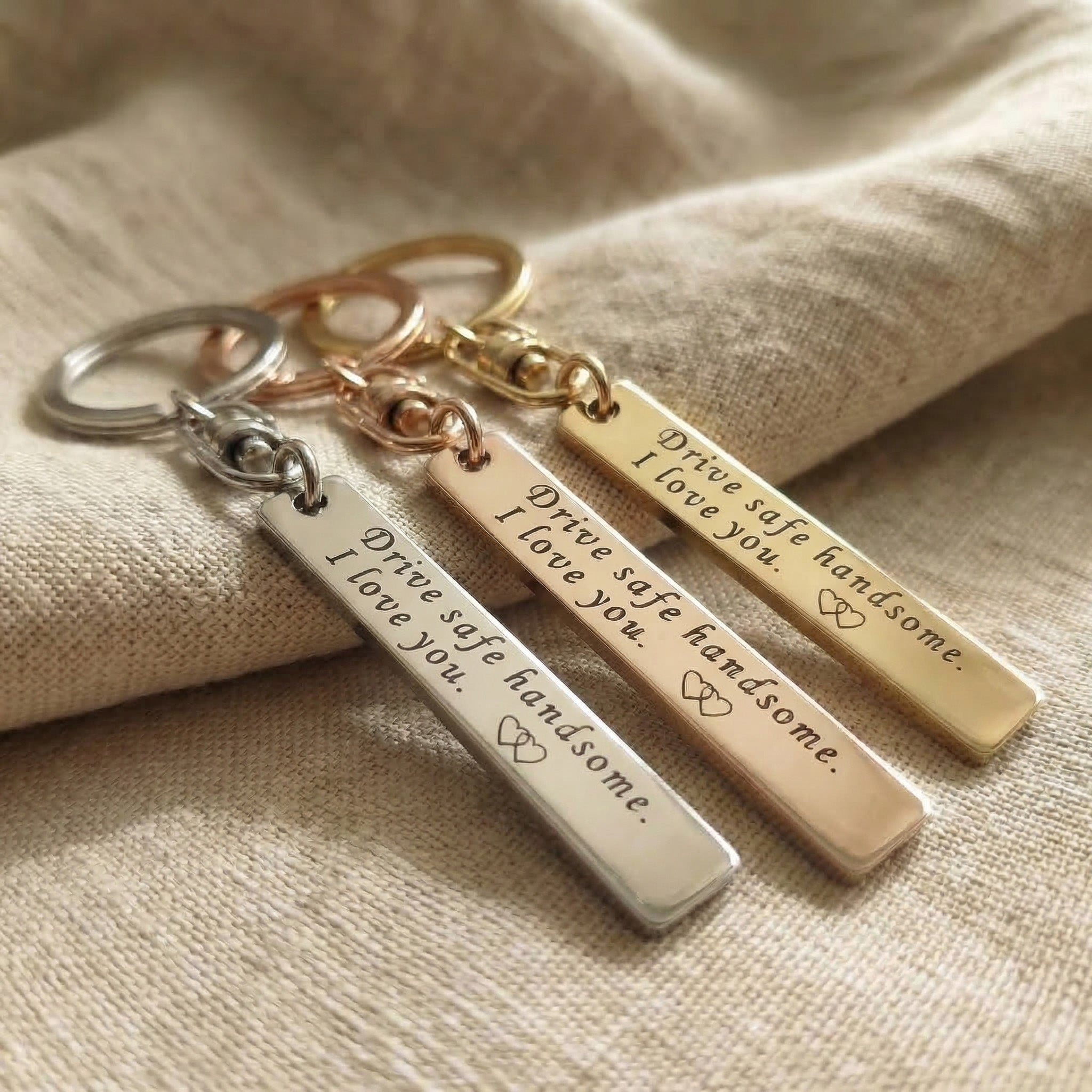 Personalised tag keyring comparison showing multiple engraved bar tags in different finishes