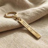 Personalised tag keyring in gold with engraved message, minimal keepsake design