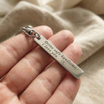Hand holding personalised tag keyring with engraved message, everyday use keepsake