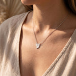 Woman wearing power of pause necklace, minimalist jewellery symbolising calm, balance and mindfulness