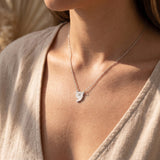 Woman wearing power of pause necklace, minimalist jewellery symbolising calm, balance and mindfulness