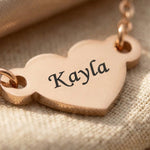 Close-up of personalised heart necklace with engraved name on heart pendant