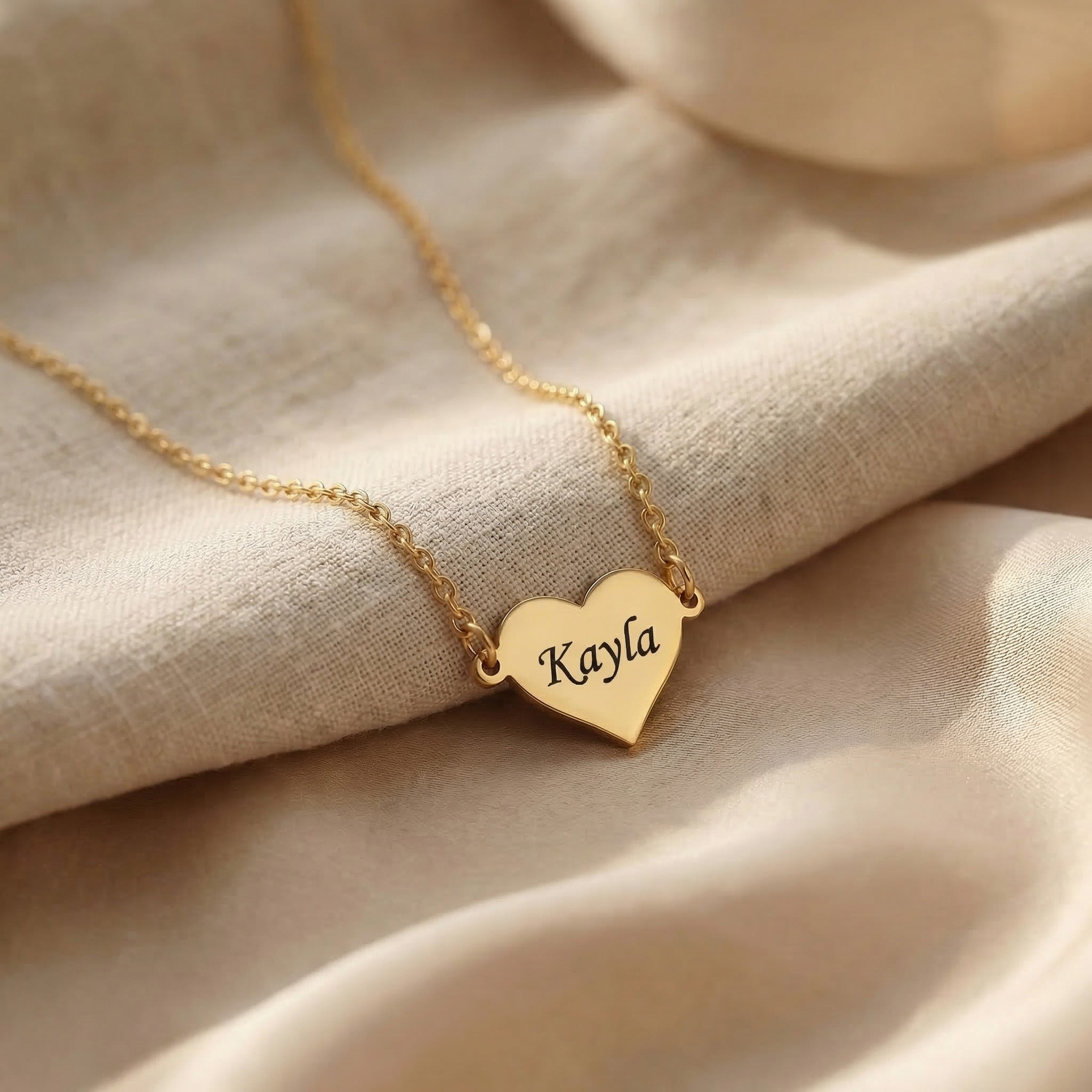 Personalised heart necklace in gold with engraved name detail