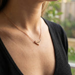 Woman wearing personalised heart necklace with engraved name, minimal everyday style