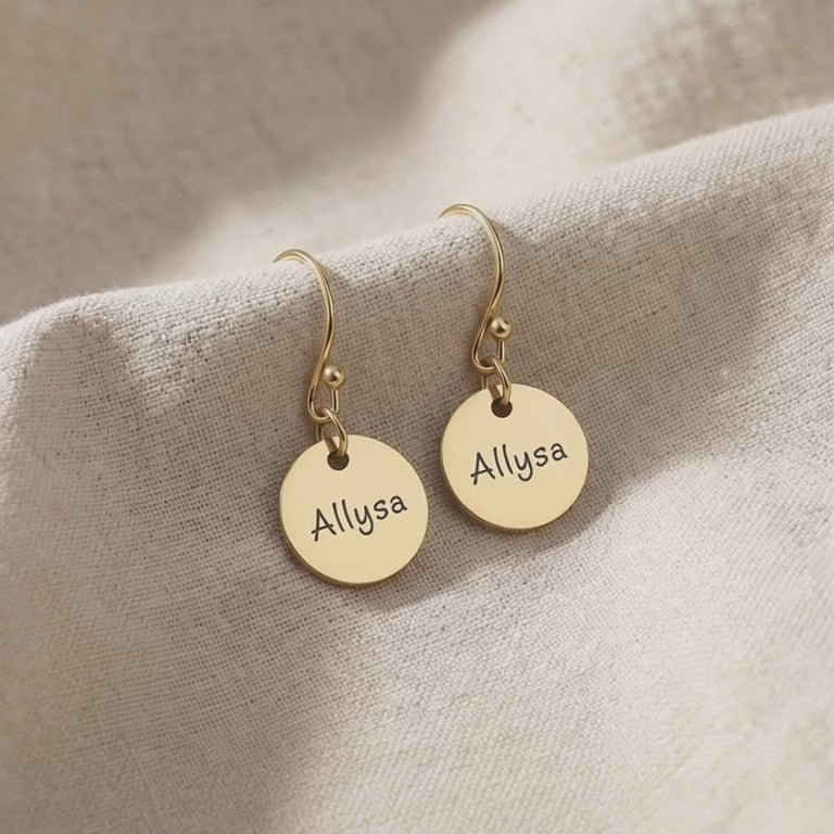 Product video showing personalised earrings with engraved name disc design
