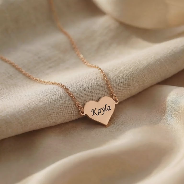Video showing personalised heart necklace with engraved name and polished finish detail