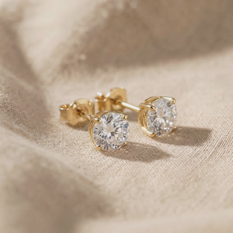 Video showing round stud earrings with sparkling stone detail and polished finish