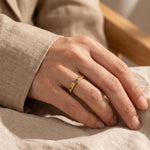 Woman wearing rainbow crystal ring, colourful gemstone jewellery for everyday style and stacking