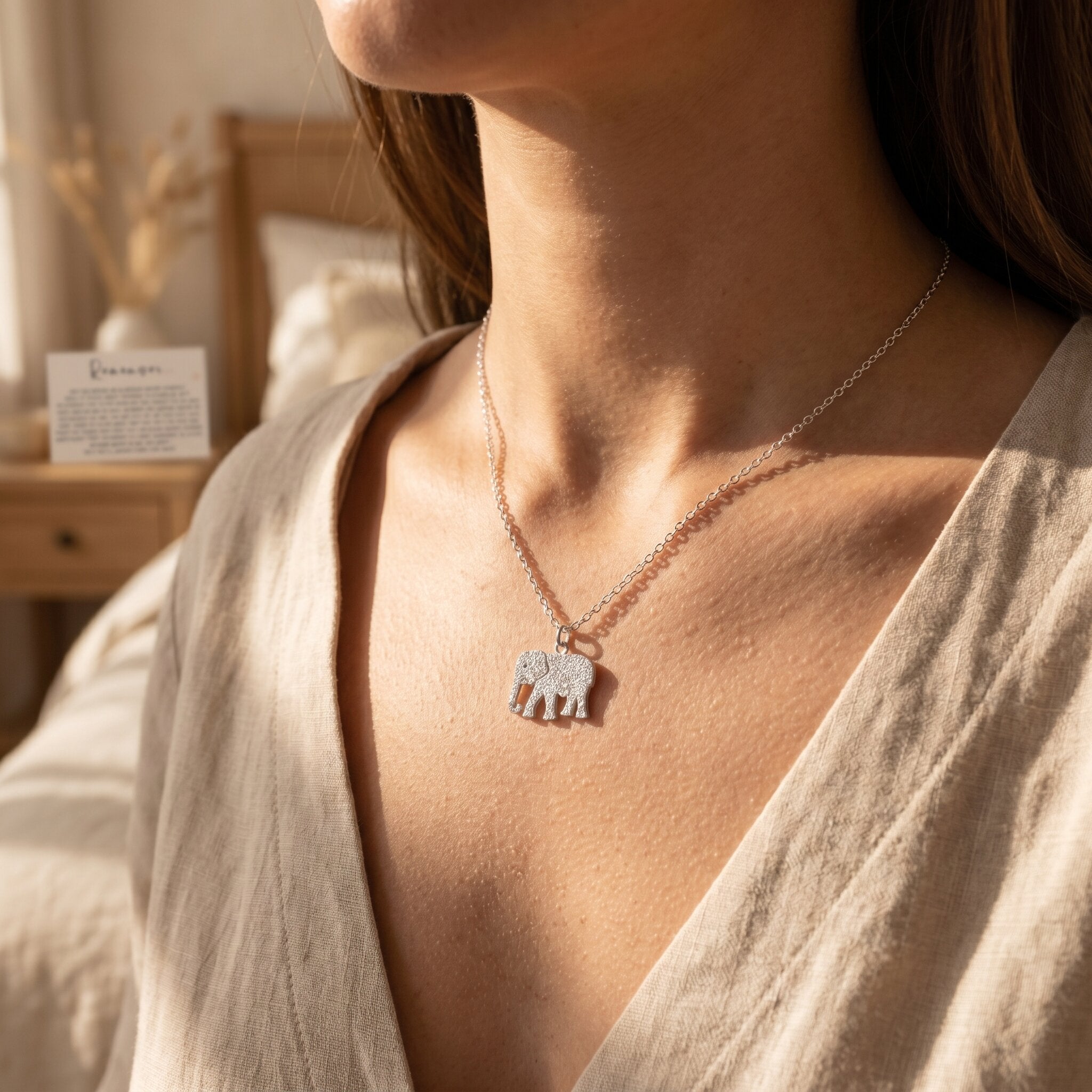 Woman wearing remember necklace with elephant pendant, symbolic jewellery for memory and emotional support