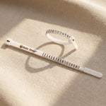 Professional ring sizer tool for accurate jewelry sizing with adjustable measuring bands in soft lighting