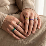 Hands wearing river ring stackable gemstone rings, stylish layered jewellery for modern everyday styling