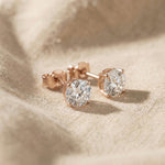 Round stud earrings in rose gold with sparkling stone detail