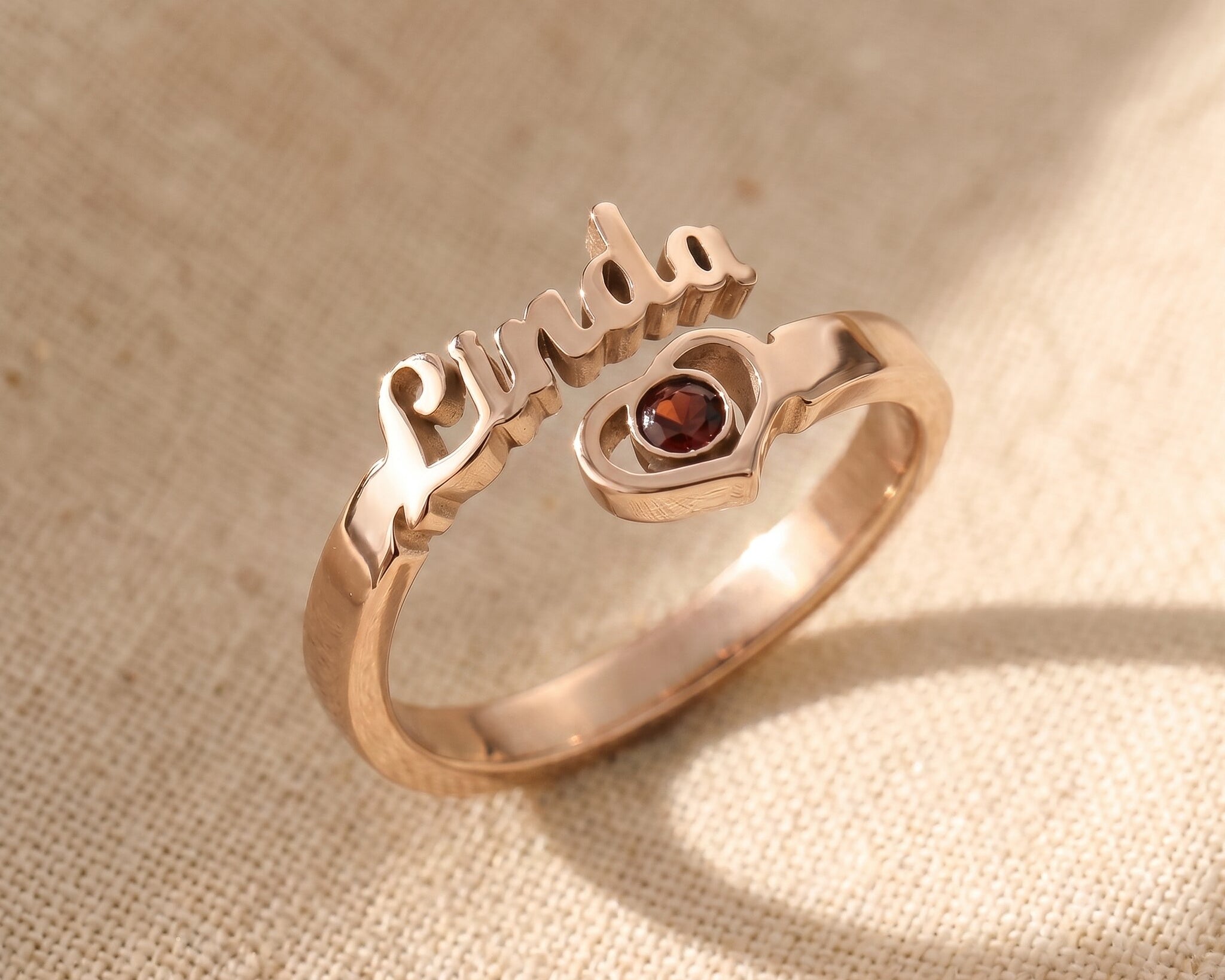 Personalised single name ring in rose gold with custom script engraving and birthstone, meaningful jewellery gift for her