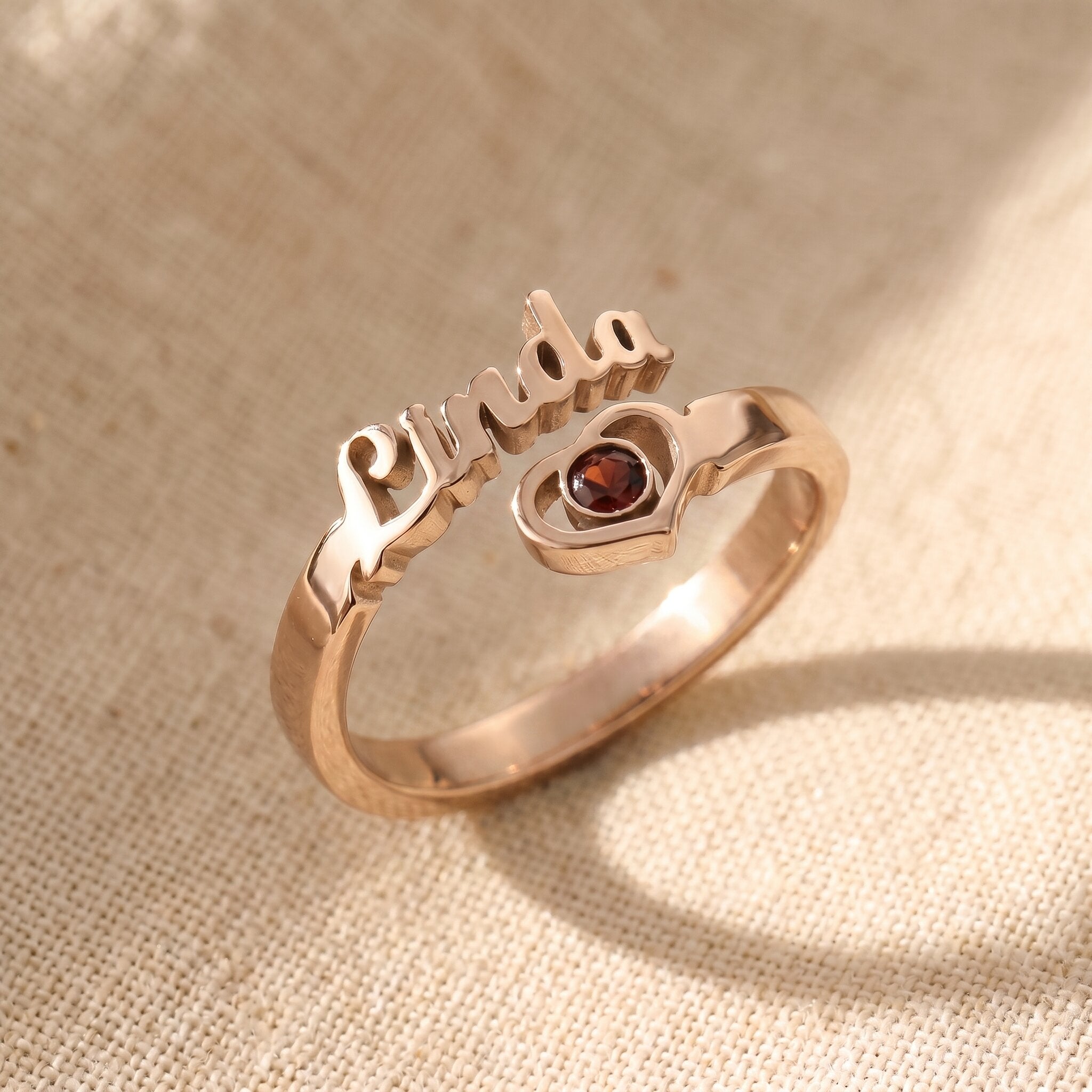 Personalised single name ring in rose gold with custom script engraving and birthstone, meaningful jewellery gift for her