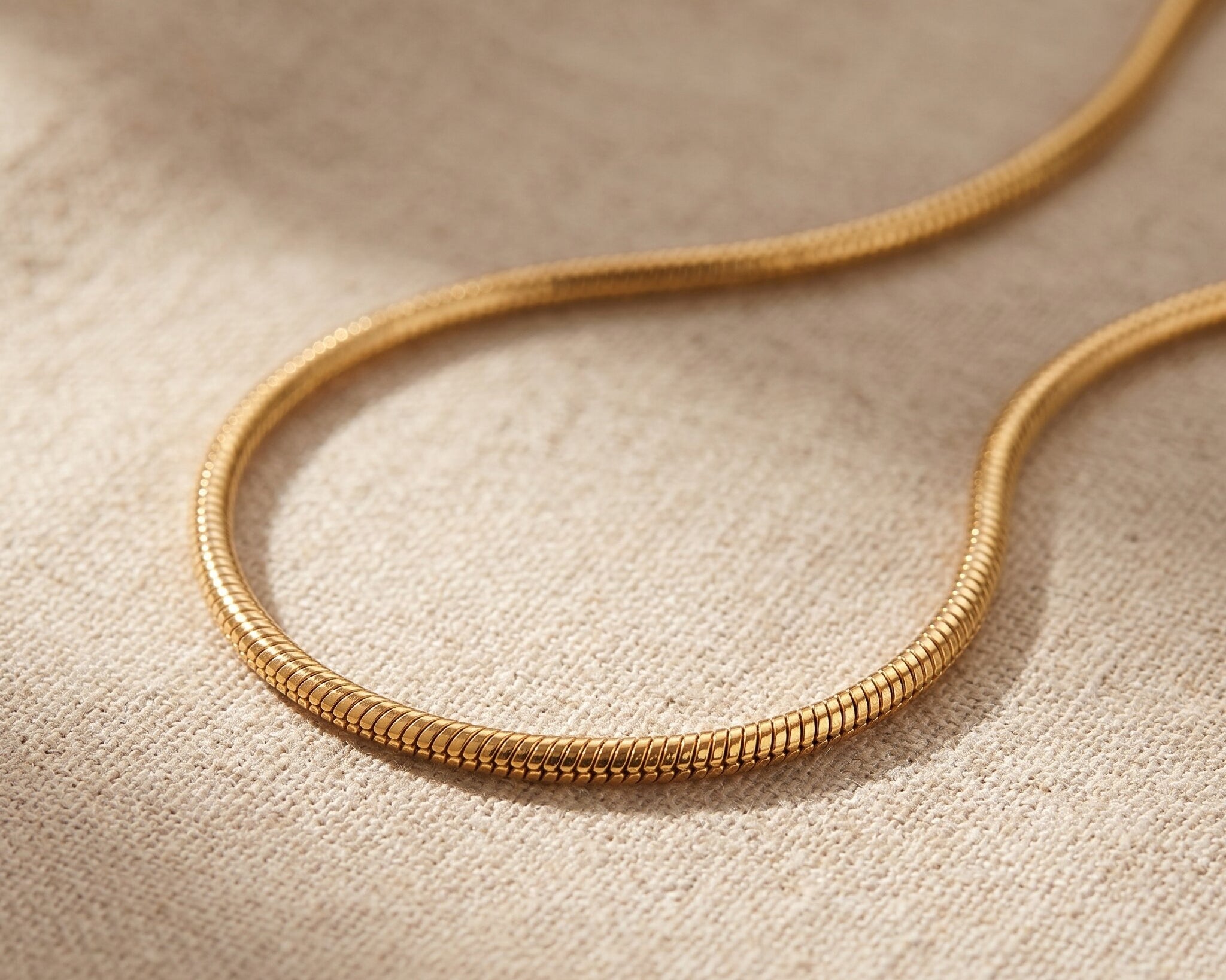Snake chain necklace in gold with sleek flat chain design, minimalist jewellery for lpendant and everyday wear
