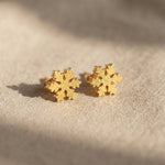 Sparkling snowflake earrings in gold with crystal detail, delicate festive jewellery gift idea