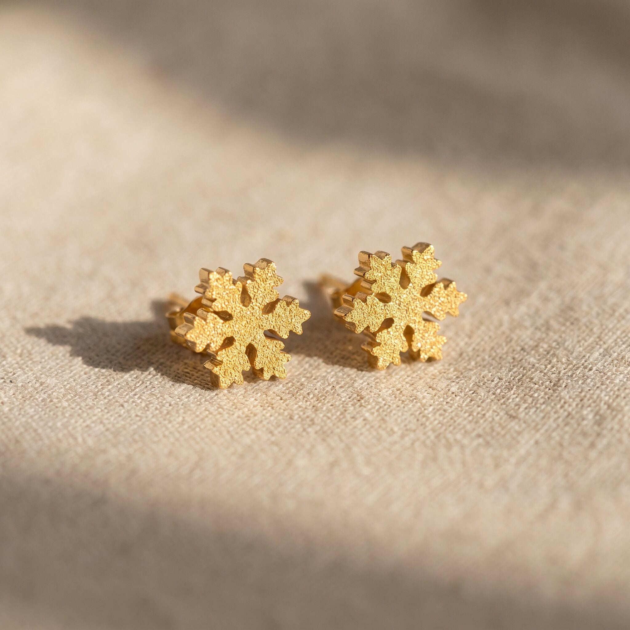 Sparkling snowflake earrings in gold with crystal detail, delicate festive jewellery gift idea