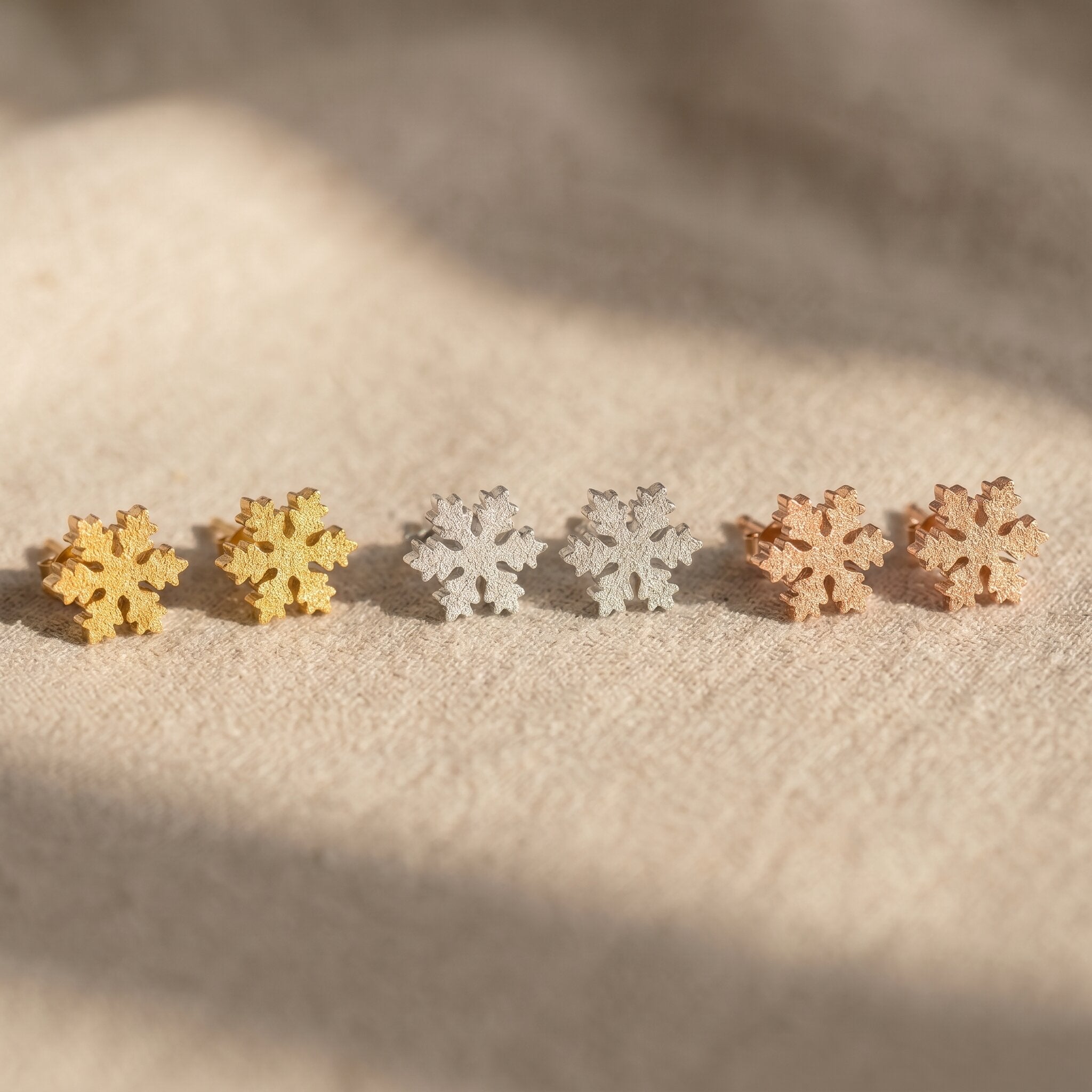 Sparkling snowflake earrings tone comparison showing gold, silver and rose gold winter jewellery options