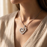 Woman wearing swirl of my heart necklace, symbolic jewellery celebrating love, family and connection