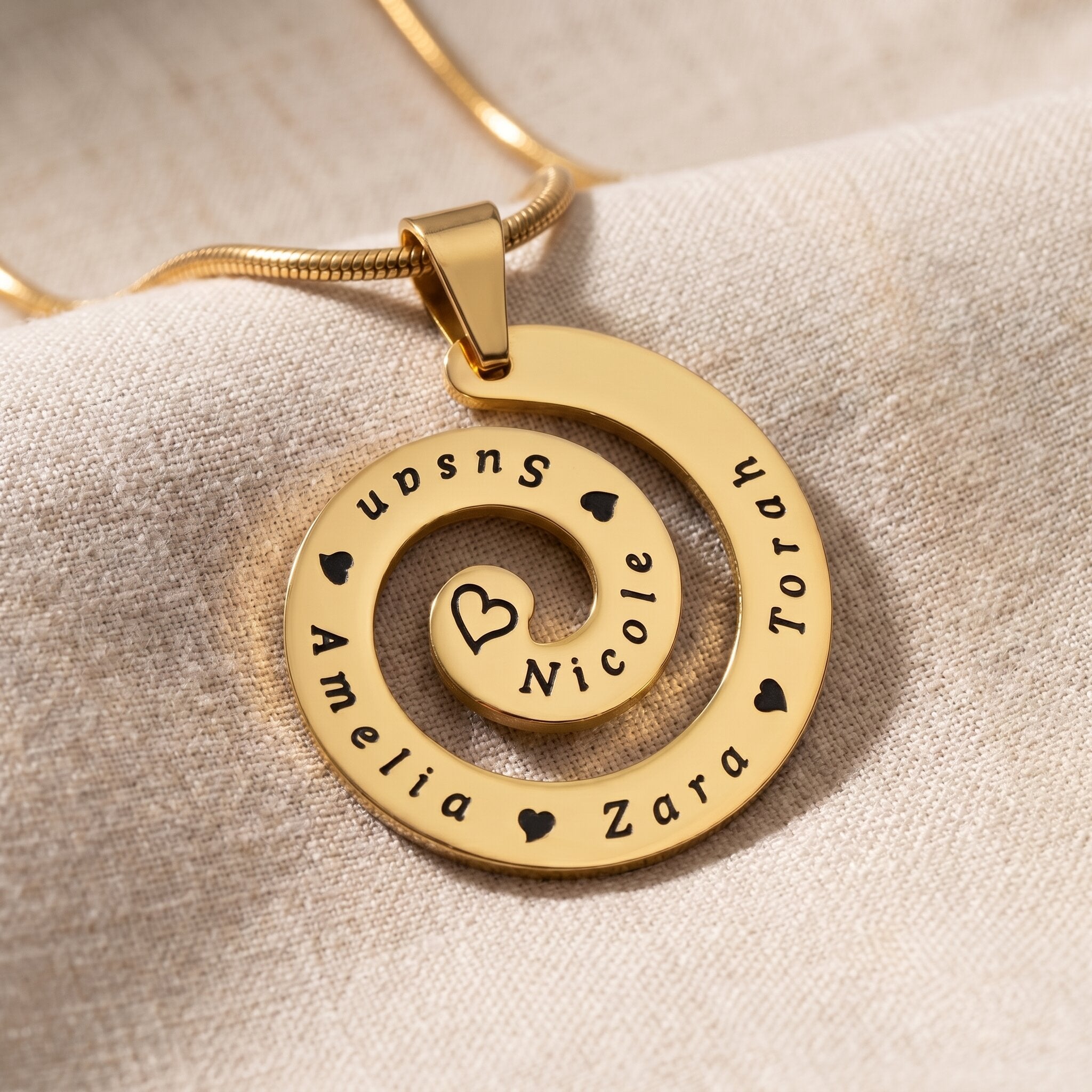 Swirl of time necklace in gold with engraved symbolic design, meaningful keepsake jewellery gift