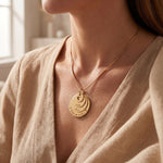 Woman wearing tower of love necklace, layered disc family jewellery and meaningful gift for mum