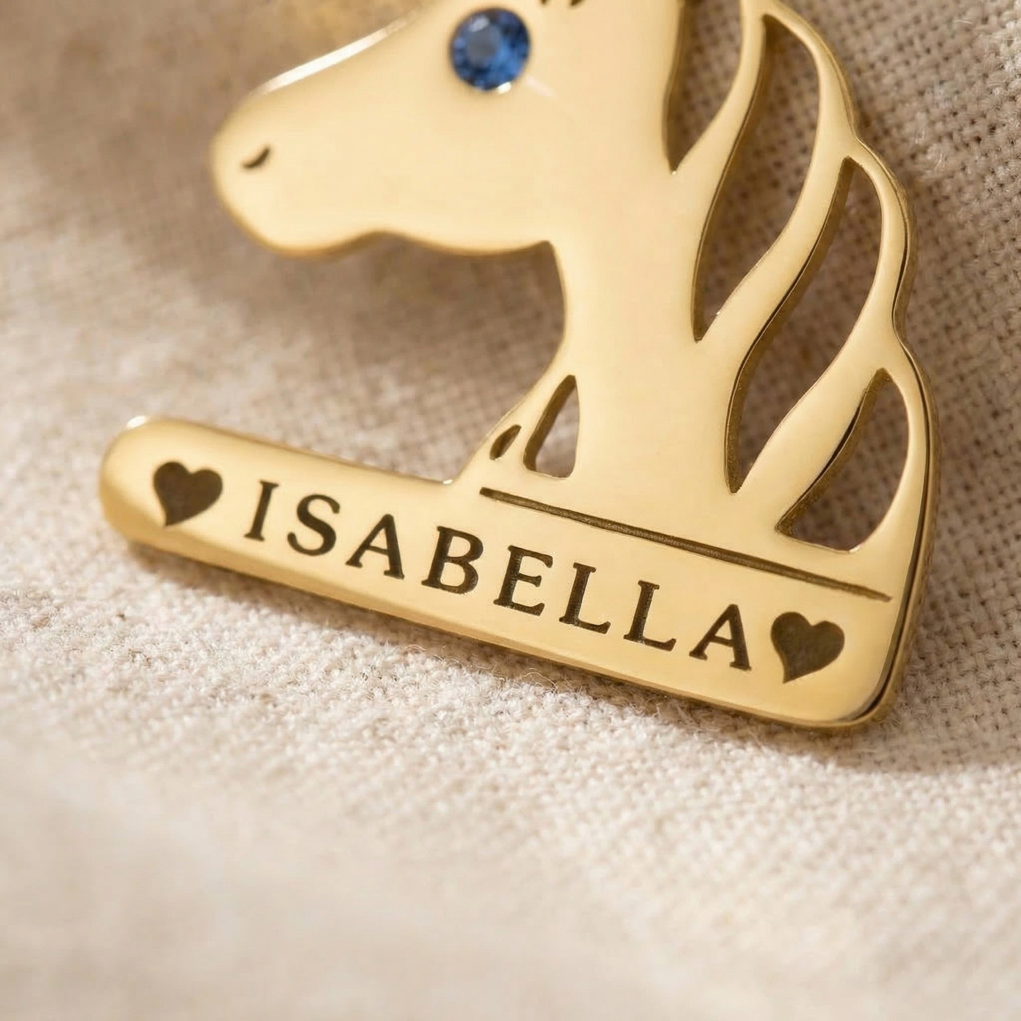 Close-up of unicorn head name necklace with engraved name and birthstone detail