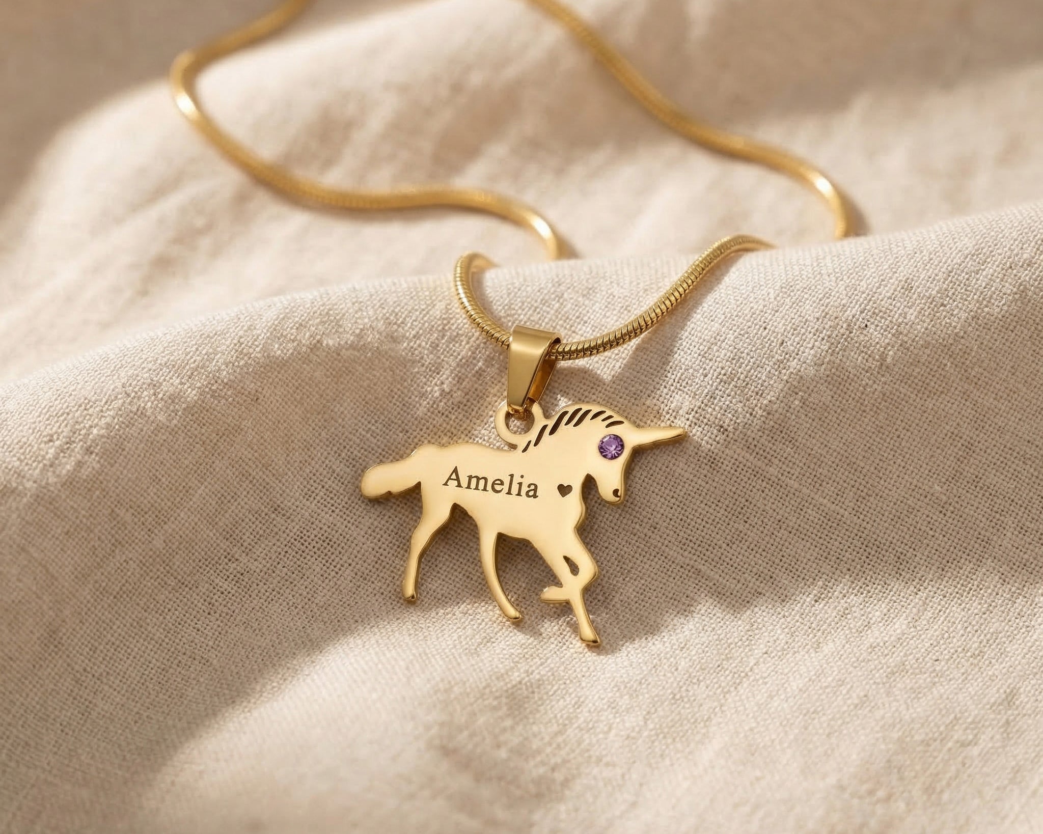 Unicorn name necklace in gold with personalised name and playful unicorn design