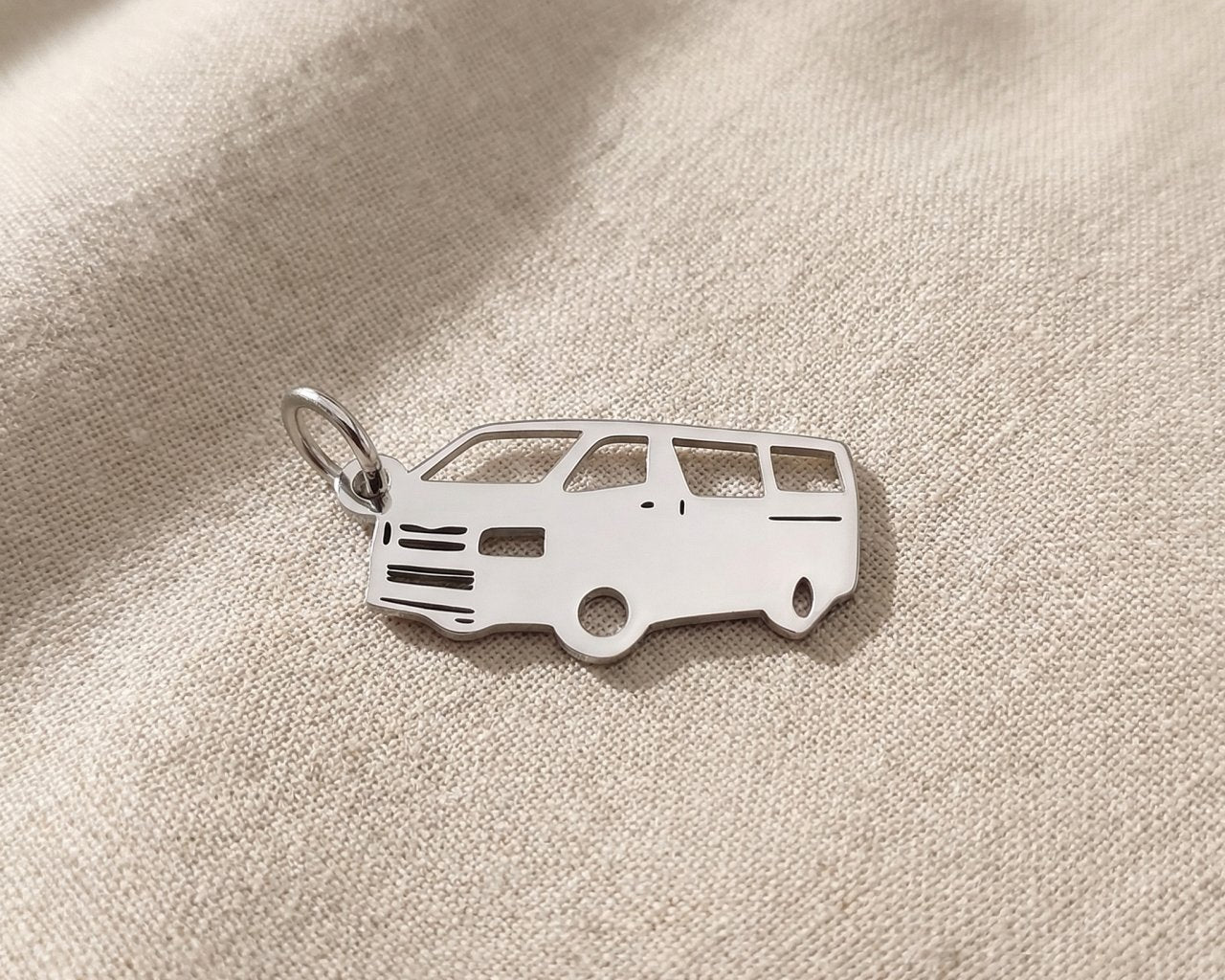 Silver people mover van charm for keyring symbolizing family travel, road trips, and shared life memories